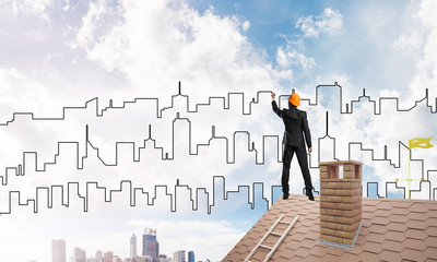 Man architect draw silhouette of modern city on blue sky. Mixed media