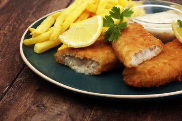 traditional British fish and chips on wooden background