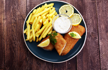 traditional British fish and chips on wooden background