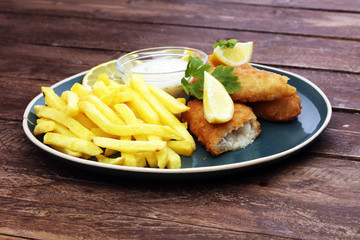 traditional British fish and chips on wooden background