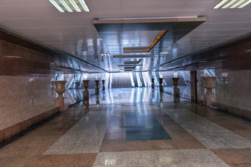 Wide underground passage with granite trim