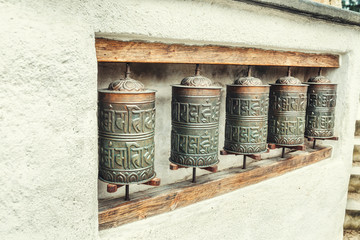 Fototapeta na wymiar The row of authentic buddhist prayer drums