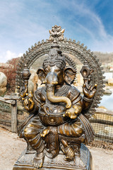 Statue of Hindu Elephant God Ganesha outdoors against dramatic sky