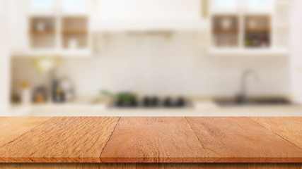 Wood table top with blur kitchen background. Suitable use for montage or made marketing your product.