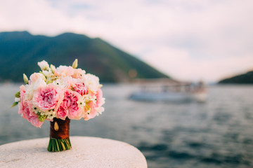 Fototapeta na wymiar A wedding bouquet near the sea. Wedding in Montenegro.