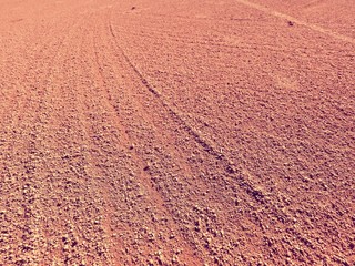 Dry light red crushed bricks surface on outdoor tennis ground