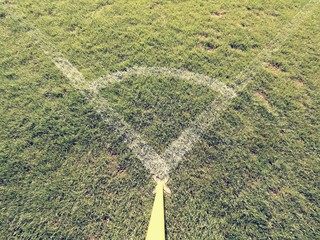 Football field corner detail with white marks and flag stick