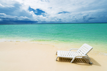 Sunbed on the white sand beach.Copy space
