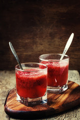 Strawberry jelly in glasses, vintage wooden background, selective focus
