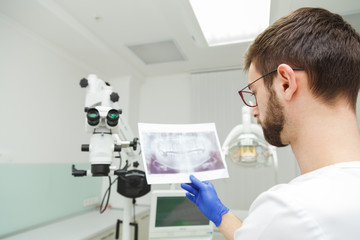 Dentist looks at a snapshot of teeth