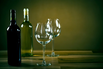 Wine bottles with grapes and cheese  on wooden rustic background. copy space