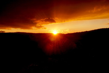 sunset landscape small mountain with clouds in the sky red