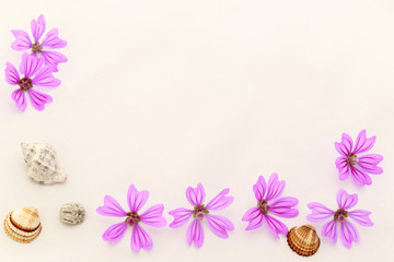 Postcard with empty place for inscription from scattered pink small flowers,  sea stone and seashells on a light background