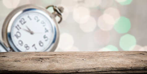 Perspective wooden table and bokeh background with pocket watch