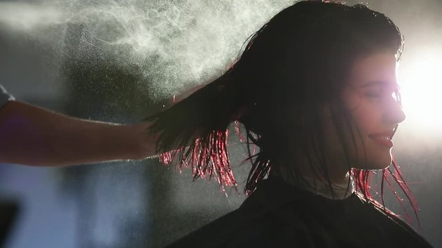 Master stylist makes the bride wedding hairstyle using spray lacquer fixing