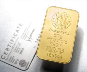 Minted gold bar weighing 50 grams with certificate. Gold ingot with assay certificate.