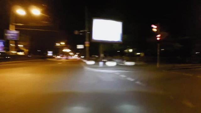 Timel apse of night streets driving. Car windshield pov point of view. City streets high speed driving.