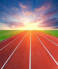 Fototapeta na wymiar Road to success. Concept of competition. Athletics sport track and sky