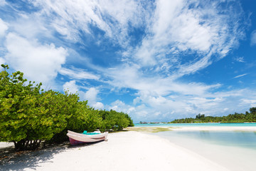 Fototapeta na wymiar Wooden boat on the white sand beach.Maldives islands