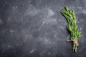 Rosemary on concrete table. Herbs and spices. Cooking ingredients. Top view and copy space for your recipe - Powered by Adobe
