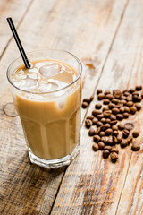 iced coffee with beans for cold summer drink on wooden background