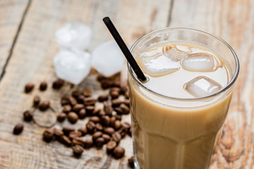 iced coffee with beans for cold summer drink on wooden background