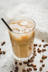 Ice coffee with milk and beans for lunch on stone background