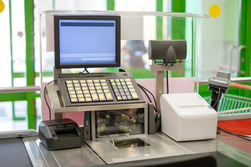 Empty cash desk with computer terminal in modern supermarket
