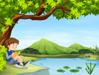 Obraz na płótnie Canvas Boy reading book by the pond