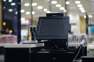 Cash desk with large screen and card payment terminal in modern store
