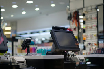 Cash desk with large screen and card payment terminal in modern store - obrazy, fototapety, plakaty