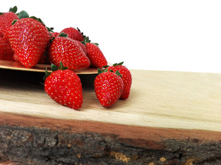 Delicious and fresh strawberries on a wooden table