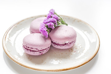 lady morning with macaroons and mauve flowers white desk background