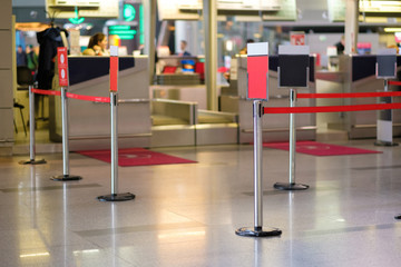 Waiting lines and information labels in front of check-in desks in airport