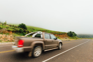 Obraz na płótnie Canvas Pickup truck travels along a road with fog Tucuman, Argentina