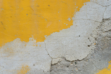 background / Detail of a weathered facade with yellow and white color