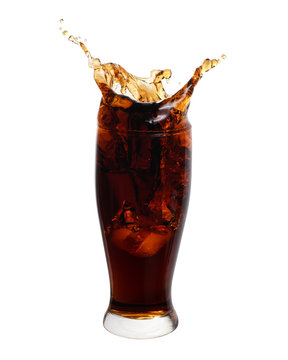 Cola splashing out of a glass isolated on white background.