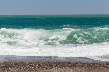 Beautiful wave washing pebble beach
