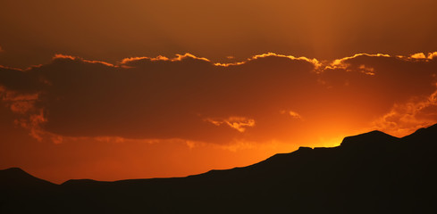 Brilliant orange sunrise over clouds.