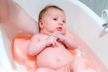 Bathing a newborn baby.
