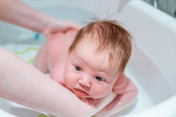 Bathing a newborn baby.