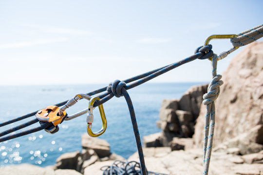 Climbing ropes and carabiners  stretched across sea view