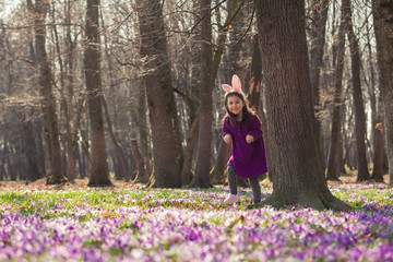 Little girl with banny ears in spring park