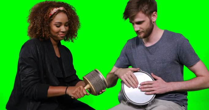 Happy musicians playing cabasa and drum