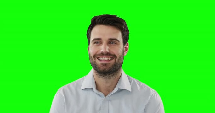 Young man standing against green screen
