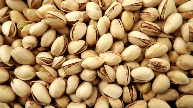 Food background. Roasted pistachio nuts seed with shell close up. Dieting concept. Dolly slider shot 4K ProRes HQ codec