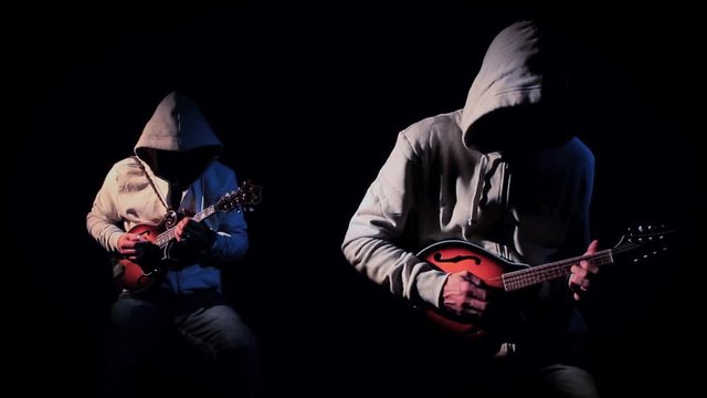 Anonymous Hooded Mandolin Players on Black Background