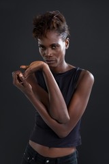 Androgynous man posing against grey background