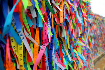 Colorful ribbons in front of a catholic church called Senhor do Bonfim in Salvador, Bahia in Brazil. Famous touristic place where people make wishes while tie the ribbons in the Carnival land.