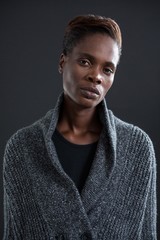 Obraz premium Androgynous person in sweater against grey background